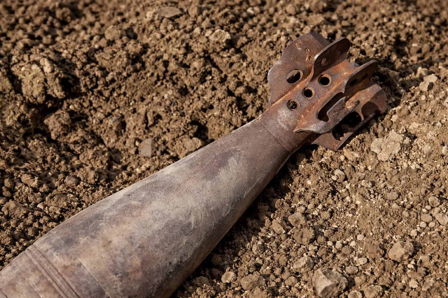 Second World War mortar shell in churned-up earth
